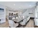 Open concept dining room with seating for twelve and kitchen with breakfast bar at 7519 Marker Ave, Kissimmee, FL 34747
