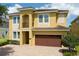 Charming two-story home with a brown garage door and a beautiful brick driveway at 7519 Marker Ave, Kissimmee, FL 34747