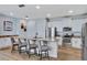 Bright kitchen featuring white cabinets, stainless steel appliances, and a granite island at 7519 Marker Ave, Kissimmee, FL 34747