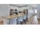 Modern kitchen with stainless steel appliances, granite countertops, and breakfast bar seating at 7519 Marker Ave, Kissimmee, FL 34747