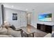 Comfortable living room featuring modern flooring, stylish furniture, and a flat-screen television at 7519 Marker Ave, Kissimmee, FL 34747