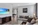 Upstairs living room featuring a sofa, a television, and a game room in the distance at 7519 Marker Ave, Kissimmee, FL 34747