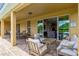 Covered outdoor patio featuring sliding glass doors, outdoor seating, and brick pavers at 7519 Marker Ave, Kissimmee, FL 34747