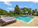 Backyard pool with a private in-ground pool, hot tub, brick pavers, and lounge chairs at 7519 Marker Ave, Kissimmee, FL 34747