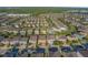Aerial view showing a home's location in a community with mature trees at 7643 Wilmington Loop, Kissimmee, FL 34747