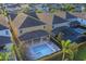 Aerial view of a large home featuring a private pool, spa, and screened-in patio at 7643 Wilmington Loop, Kissimmee, FL 34747