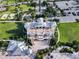 Aerial view of a clubhouse with parking, a beach volleyball court, and maintained green spaces at 7643 Wilmington Loop, Kissimmee, FL 34747