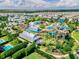 An aerial view of a neighborhood waterpark featuring colorful slides and pools that enhance the community's appeal at 7643 Wilmington Loop, Kissimmee, FL 34747