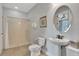 Bright bathroom with a walk-in shower and a pedestal sink and fixtures at 7643 Wilmington Loop, Kissimmee, FL 34747