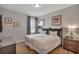 Cozy bedroom showcasing two beds, nautical artwork, and wood flooring at 7643 Wilmington Loop, Kissimmee, FL 34747