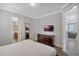 Cozy bedroom featuring a mounted TV, wood floors, and ensuite bathroom access at 7643 Wilmington Loop, Kissimmee, FL 34747