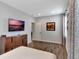 Bedroom view showcasing dresser, tv, and large window with stylish curtains at 7643 Wilmington Loop, Kissimmee, FL 34747