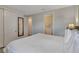 Bedroom with white bedspread and connecting door to bathroom at 7643 Wilmington Loop, Kissimmee, FL 34747