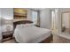 Comfortable bedroom featuring a queen-size bed, modern lamps, and light gray walls at 7643 Wilmington Loop, Kissimmee, FL 34747