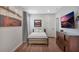 Bedroom featuring a bed, dresser, and mounted television at 7643 Wilmington Loop, Kissimmee, FL 34747