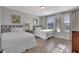 Bright bedroom with twin beds, hardwood floors, large windows, and neutral wall color at 7643 Wilmington Loop, Kissimmee, FL 34747