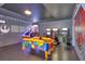 Spacious game room with an air hockey table and multiple arcade game consoles at 7643 Wilmington Loop, Kissimmee, FL 34747