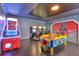 Spacious game room with arcade games, air hockey table and Star Wars themed wall art at 7643 Wilmington Loop, Kissimmee, FL 34747