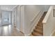 Hallway features tile flooring, a stairway with wood treads, and access to the front door at 7643 Wilmington Loop, Kissimmee, FL 34747