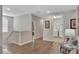 Bright hallway with wood floors leads to laundry room; decorated with stylish gray chair at 7643 Wilmington Loop, Kissimmee, FL 34747