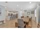 Open-concept kitchen and dining area with stainless steel appliances, breakfast bar, and ample seating at 7643 Wilmington Loop, Kissimmee, FL 34747
