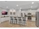 Open kitchen features granite countertops, stainless appliances, and a breakfast bar with seating at 7643 Wilmington Loop, Kissimmee, FL 34747