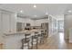 Open kitchen with granite counters, stainless appliances, white cabinetry, and a breakfast bar at 7643 Wilmington Loop, Kissimmee, FL 34747