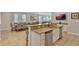 Open kitchen concept with granite counters, stainless appliances, and seamless flow into the dining and living areas at 7643 Wilmington Loop, Kissimmee, FL 34747