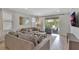 Comfortable living room with neutral tones, plush seating, and sliding glass doors to outdoor patio at 7643 Wilmington Loop, Kissimmee, FL 34747