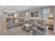 Spacious living room with two sofas, a glass coffee table, and a view of the dining area at 7643 Wilmington Loop, Kissimmee, FL 34747