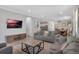 Open-concept living space with modern decor, a TV, and an adjacent dining area at 7643 Wilmington Loop, Kissimmee, FL 34747