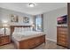 Beautiful main bedroom with wood accents, tv, and bedside tables at 7643 Wilmington Loop, Kissimmee, FL 34747