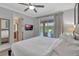 Comfortable bedroom with en-suite bathroom and sliding glass doors to an outdoor area at 7643 Wilmington Loop, Kissimmee, FL 34747