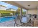 Cozy outdoor dining area with a grill, overlooking the beautiful pool and backyard at 7643 Wilmington Loop, Kissimmee, FL 34747