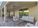 Covered patio features comfortable seating and a dining area perfect for outdoor entertaining at 7643 Wilmington Loop, Kissimmee, FL 34747