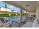 Inviting outdoor patio with lounge seating, dining area, and a grill, perfect for entertaining at 7643 Wilmington Loop, Kissimmee, FL 34747