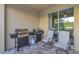 Covered patio with stainless steel gas grill station and outdoor seating area at 7643 Wilmington Loop, Kissimmee, FL 34747