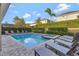 Beautiful pool and spa area with ample lounge seating and lush landscaping for privacy at 7643 Wilmington Loop, Kissimmee, FL 34747
