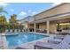 Stunning backyard pool and patio area with ample seating and a covered outdoor dining space at 7643 Wilmington Loop, Kissimmee, FL 34747