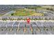 Wide aerial view of a neighborhood, showing the property's location near a pond and surrounding homes at 780 Drop Shot Dr, Davenport, FL 33896