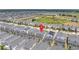 Overhead perspective of a neighborhood with a pond, emphasizing the location of the property within the community at 780 Drop Shot Dr, Davenport, FL 33896