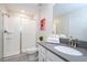 Nicely decorated bathroom with a glass shower, white cabinets, gray countertops, and bright lighting at 780 Drop Shot Dr, Davenport, FL 33896