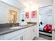 Bathroom featuring double sinks, vanity and a view into the themed bedroom at 780 Drop Shot Dr, Davenport, FL 33896