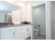 Bathroom featuring double sinks with white cabinets, gray countertop and separate toilet room at 780 Drop Shot Dr, Davenport, FL 33896