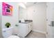 Nicely decorated bathroom with white cabinets, gray countertops, and a decorative mirror at 780 Drop Shot Dr, Davenport, FL 33896