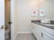 Elegant bathroom with double sinks, granite countertops, and ample cabinet space at 780 Drop Shot Dr, Davenport, FL 33896
