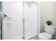 Modern bathroom featuring a walk-in shower with glass doors and white tile surround at 780 Drop Shot Dr, Davenport, FL 33896