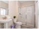 Bright bathroom with a glass-enclosed shower and pedestal sink at 780 Drop Shot Dr, Davenport, FL 33896