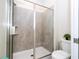 Modern bathroom showcasing a tiled shower, glass door, and efficient toilet space at 780 Drop Shot Dr, Davenport, FL 33896