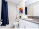 Bright bathroom featuring a shower-tub combo and vanity with a faux granite countertop at 780 Drop Shot Dr, Davenport, FL 33896
